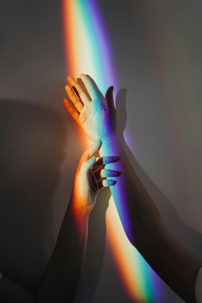 pexels-photo-3693901-3693901 A beautiful display of rainbow light casting on intertwined hands symbolizing unity and love.