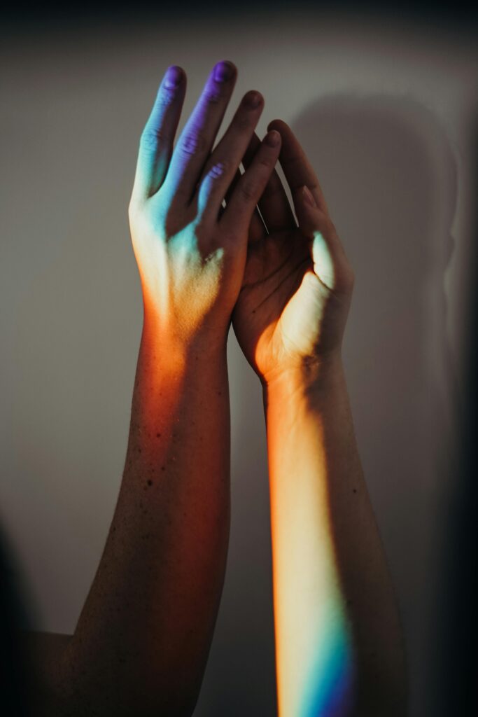 pexels-photo-3693912-3693912 Two hands touched by rainbow colors, symbolizing unity and inclusivity.